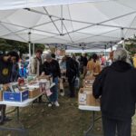 people browsing books under tent canopy